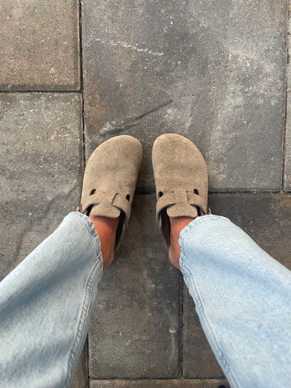 Woman wearing grey Bali Clogs paired with cozy socks, showing off a chic and comfortable casual style.